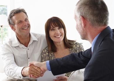 Financial advisor shaking hands with customers 